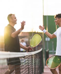 Father,And,Son,Playing,Tennis,One,To,One.,Family,Doing