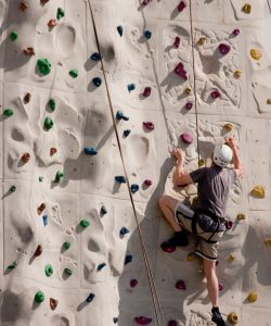 A,Climber,On,A,Rock,Wall,With,Harness,And,Ropes